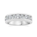 A silver diamond eternity ring featuring a row of baguette and round-cut diamonds set in a polished silver band, shown against a plain white background.