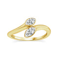 A yellow gold ring featuring two marquise-cut clear gemstones set in a curved, intertwined band design, shown on a plain white background.