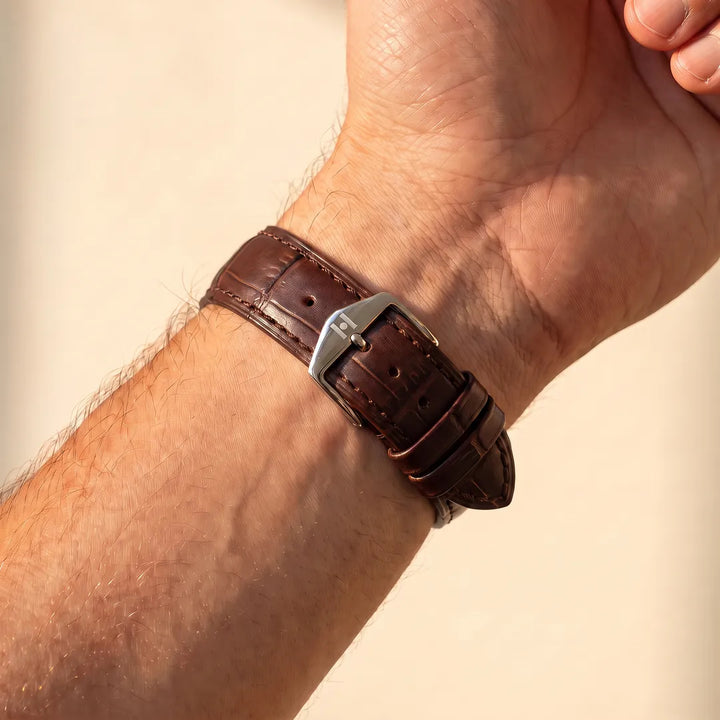 Man wearing the Hirsch Duke brown alligator-embossed leather watch band, inner wrist view