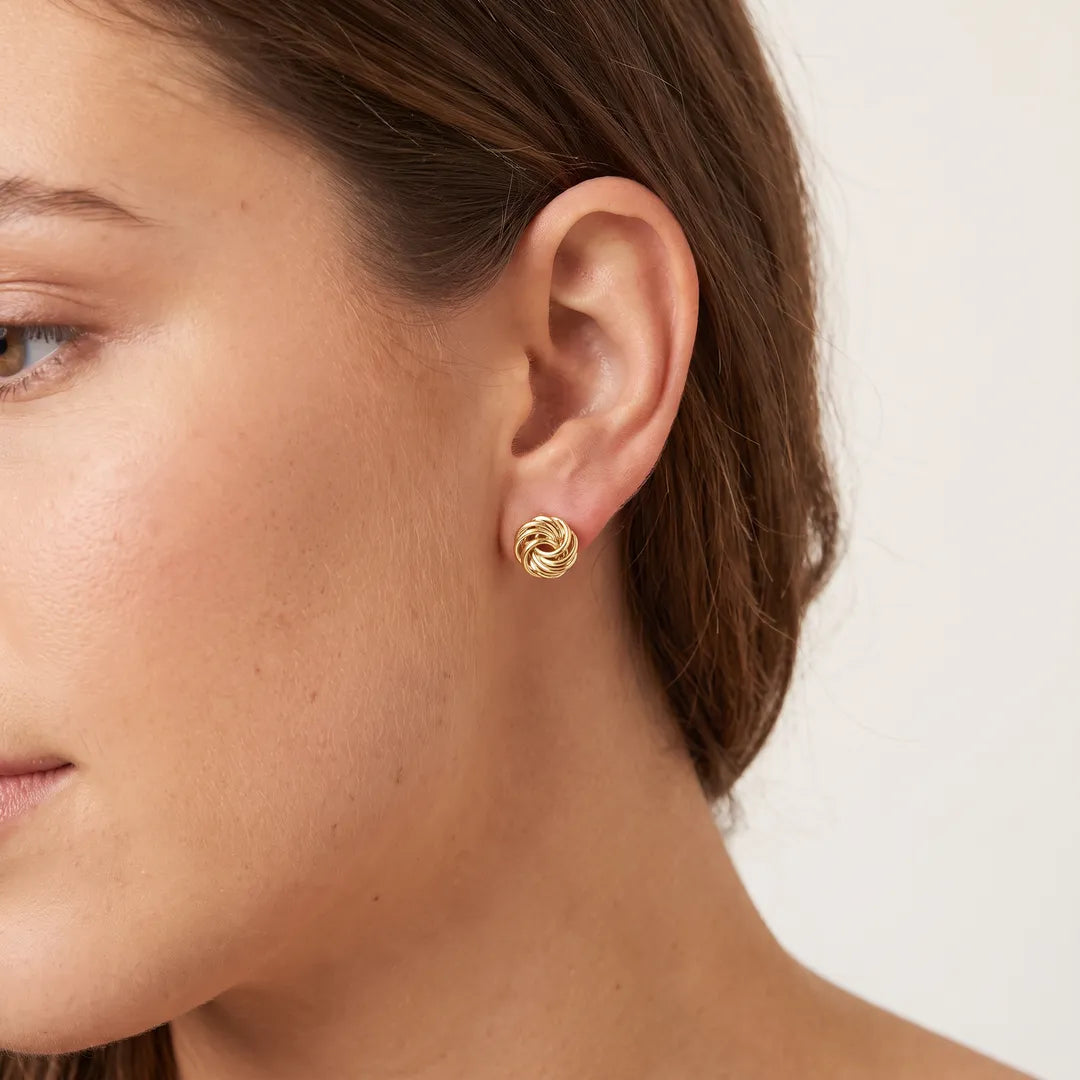 9K Yellow Gold 6mm Knot Stud Earrings worn on model's ear