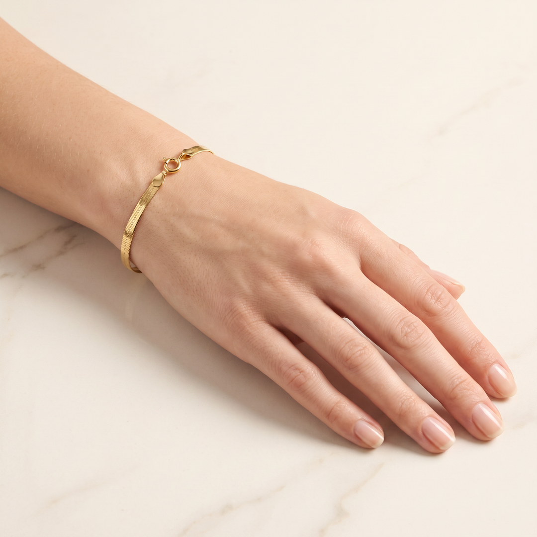 9K Yellow Gold Solid Herringbone Bracelet 18cm worn on wrist