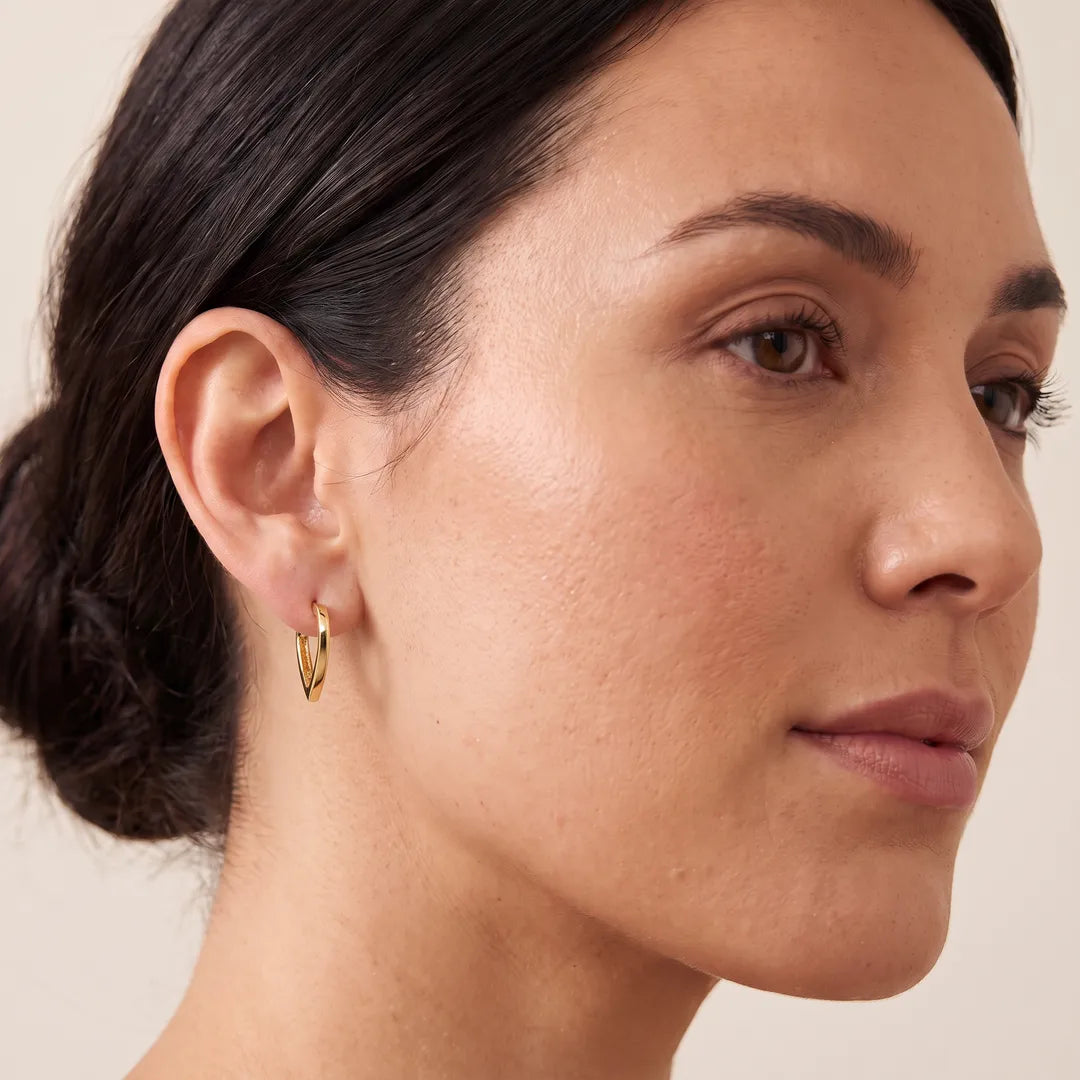 Model wearing 9K Yellow Gold Open Heart Hoop Earrings