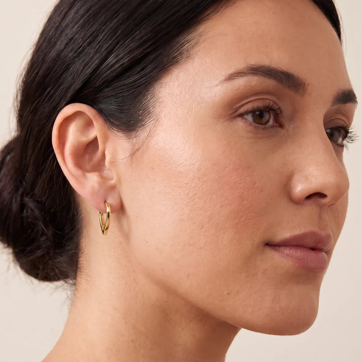 Model wearing 9K Yellow Gold Open Heart Hoop Earrings