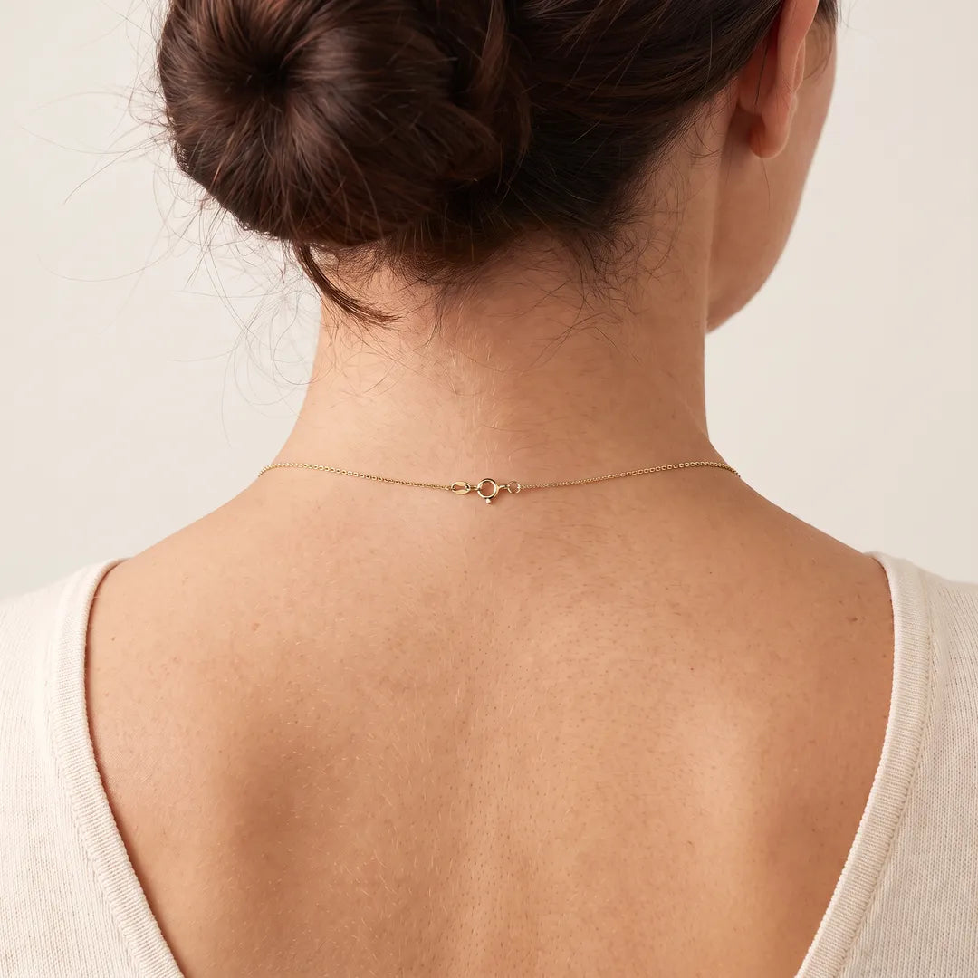 9K Yellow Gold Fine Cable Chain worn at the nape, spring-ring clasp visible