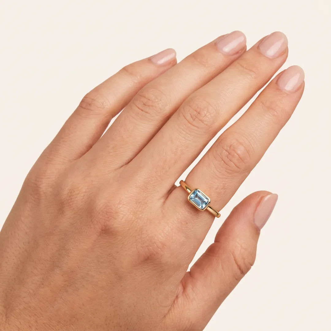 Model wearing 9K Yellow Gold Faceted Sky Blue Topaz Ring