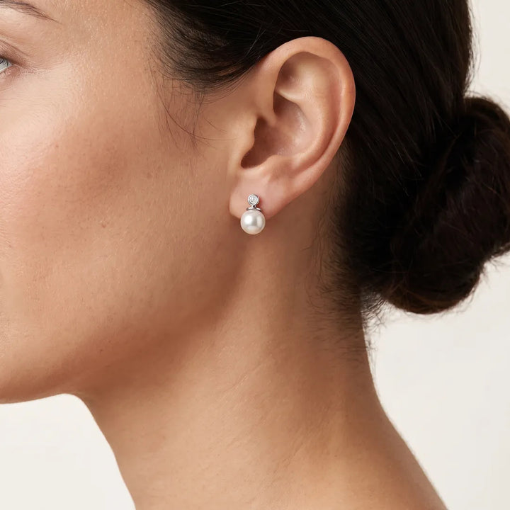 Diamond Pearl Earrings with 0.04ct Diamonds in 9K White Gold worn on model's ear - E-16543-004-W