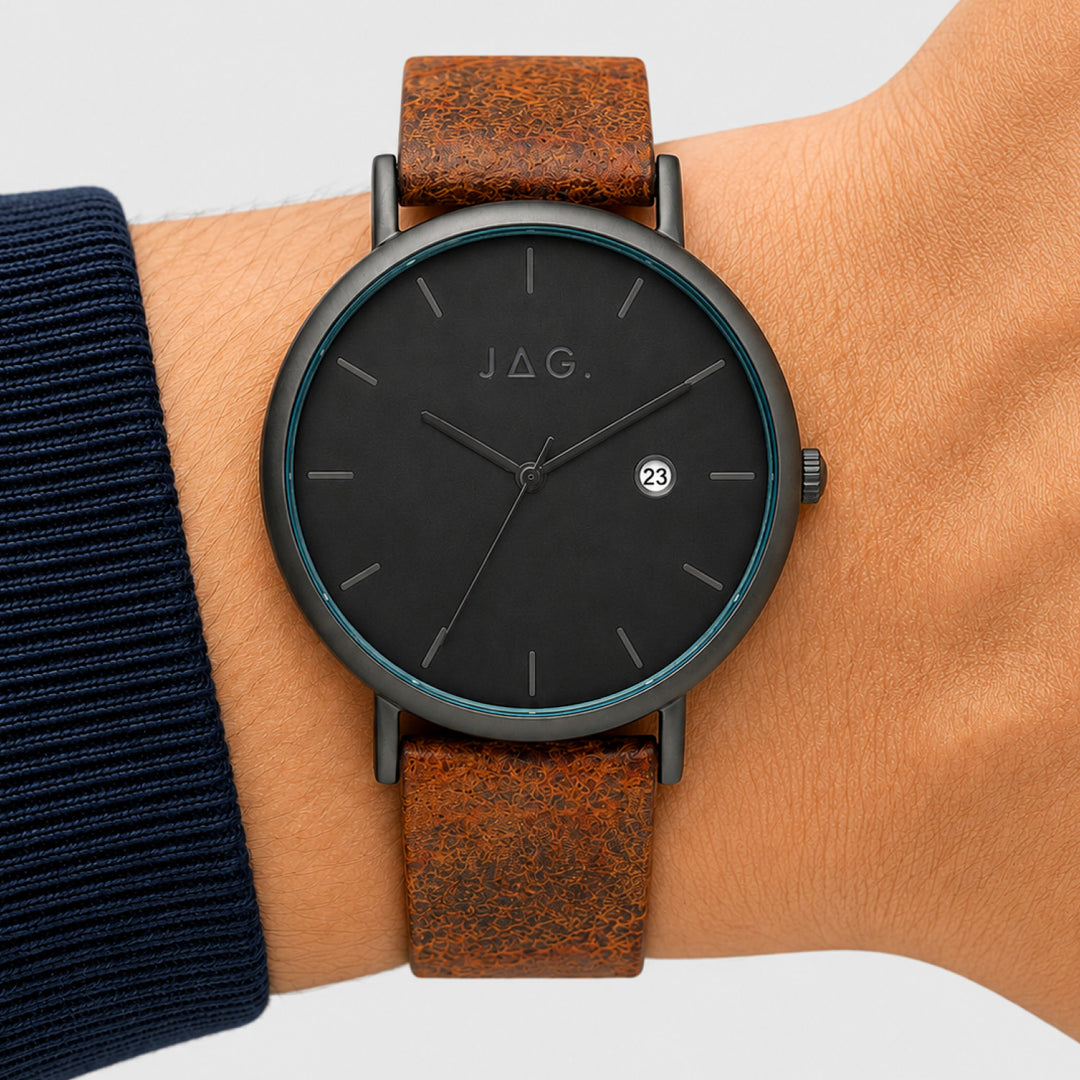 Jag Ryan black alloy 43mm watch with brown leather strap on a wrist.