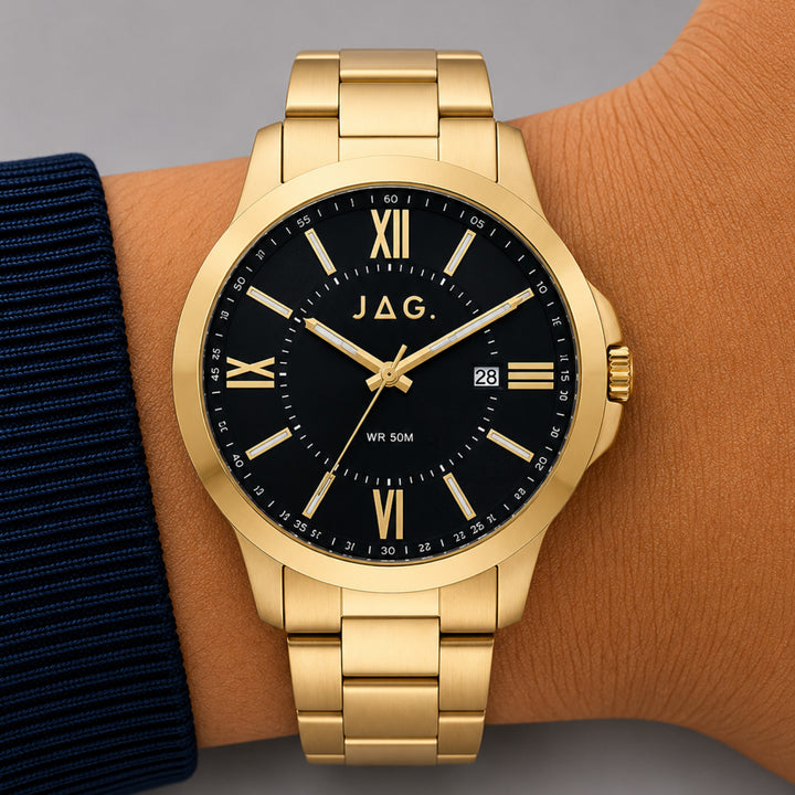 Gold JAG Xavier watch with black dial and Roman numerals on a wrist