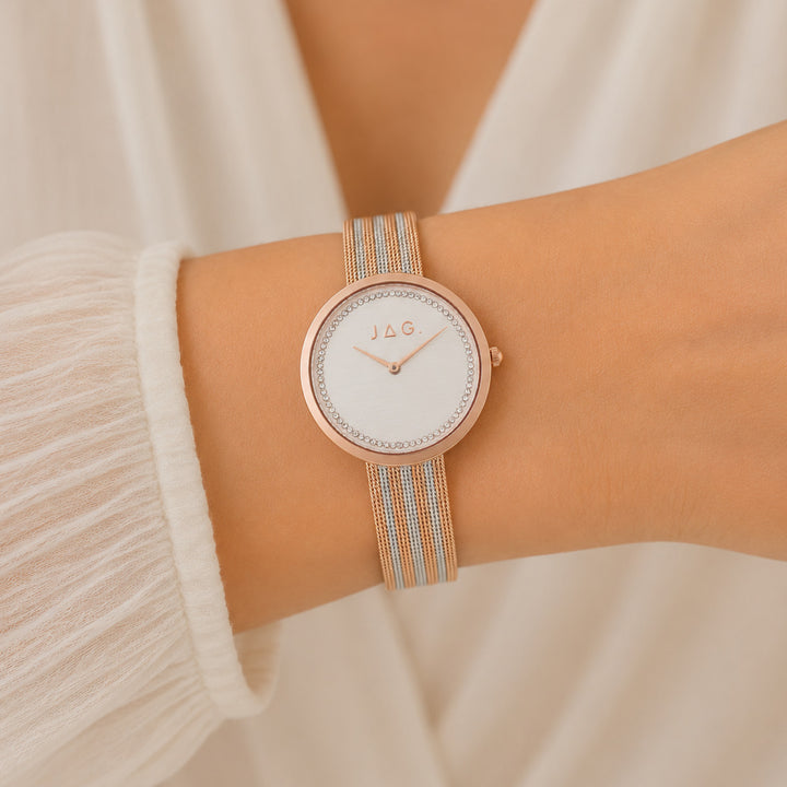Jag Tegan white alloy 34mm watch with rose gold accents on a mesh strap.