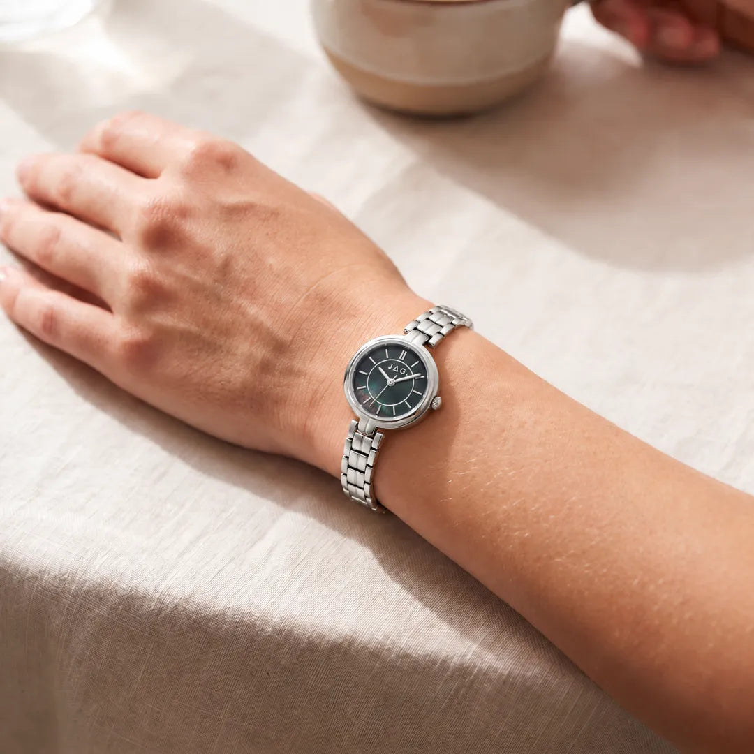 Jag Kelly womens 27mm silver watch with black mother-of-pearl dial worn on wrist