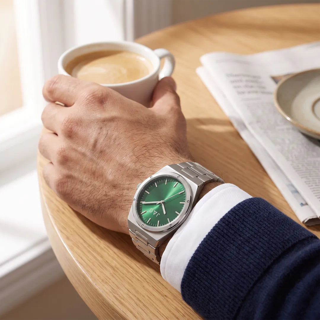 Arlo Mens Green Dial 43mm Silver Watch worn at a cafe table