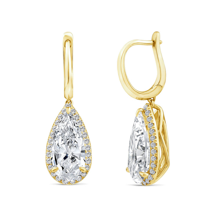 A pair of gold leverback earrings with pear-cut clear gemstones surrounded by small accent stones, shown on a plain white background.