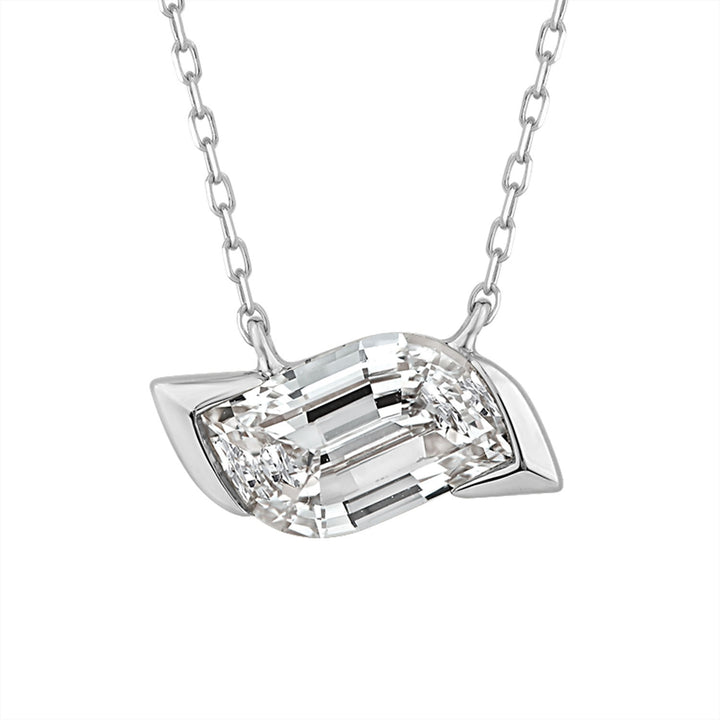 A silver pendant necklace featuring a large, clear emerald-cut diamond-like stone set in a polished silver leaf-shaped setting, suspended from a delicate silver chain against a plain white background.