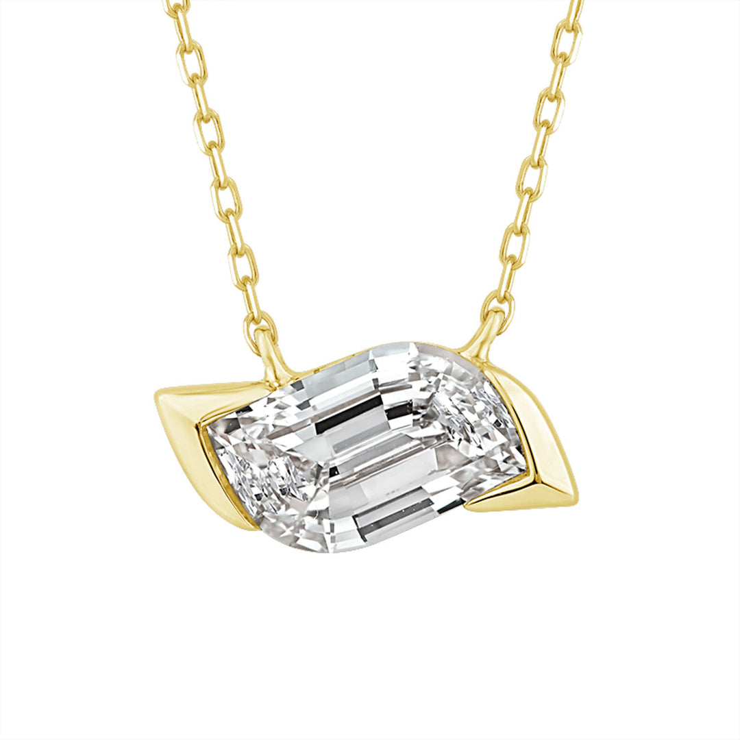A yellow gold necklace with a leaf-shaped setting holding a large rectangular emerald-cut clear gemstone, shown against a plain white background.