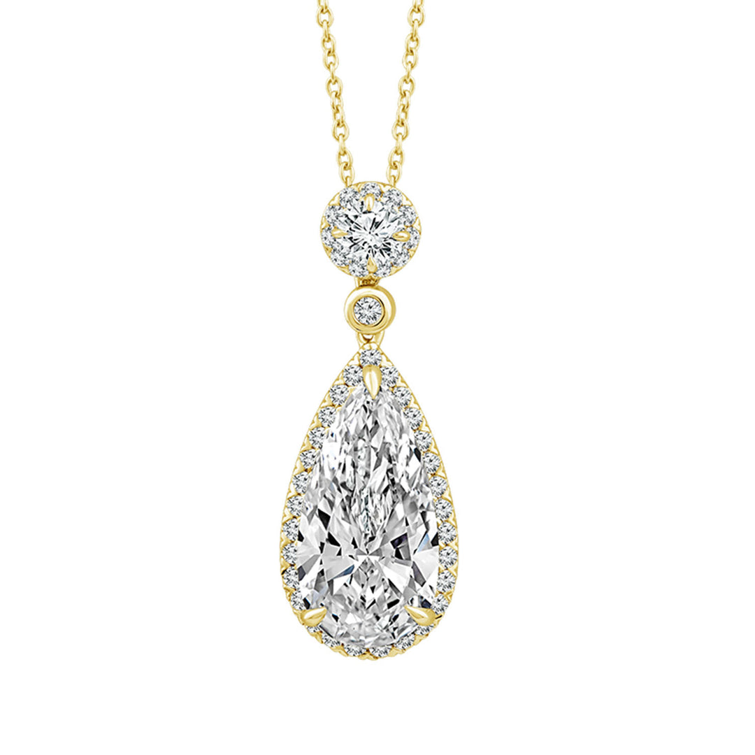 A yellow gold pendant necklace featuring a teardrop-shaped diamond pendant surrounded by a halo of smaller diamonds, with a round diamond setting above and a delicate gold chain, shown on a plain white background.