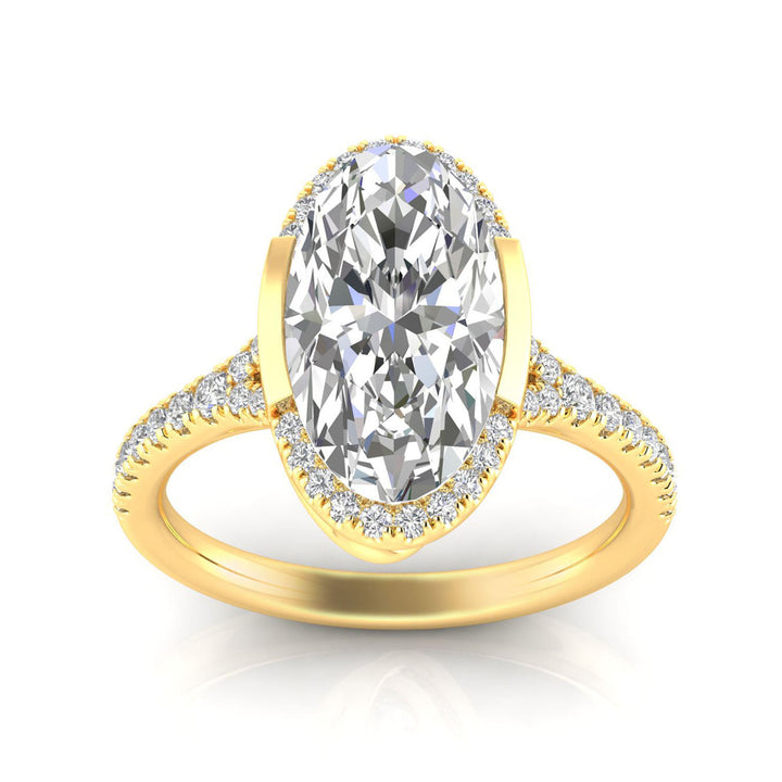 A yellow gold ring featuring a large oval-cut center stone surrounded by a halo of small clear stones, with additional pavé-set stones along the split shank, shown on a white background.