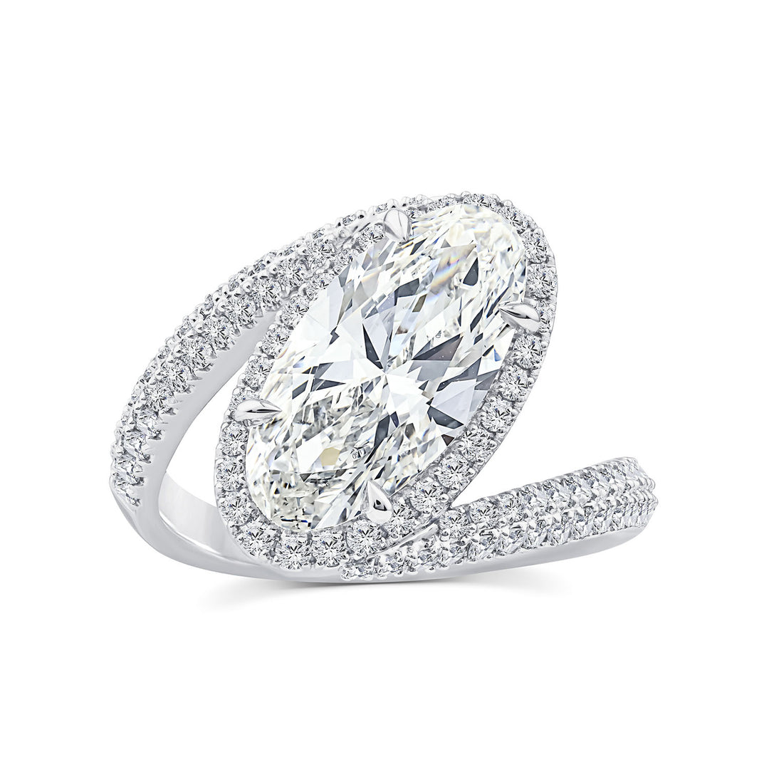 A silver-toned marquise-cut diamond ring with a halo of smaller diamonds and a pavé band, shown on a clean white background.