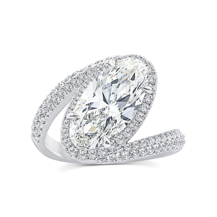 A silver-toned marquise-cut diamond ring with a halo of smaller diamonds and a pavé band, shown on a clean white background.