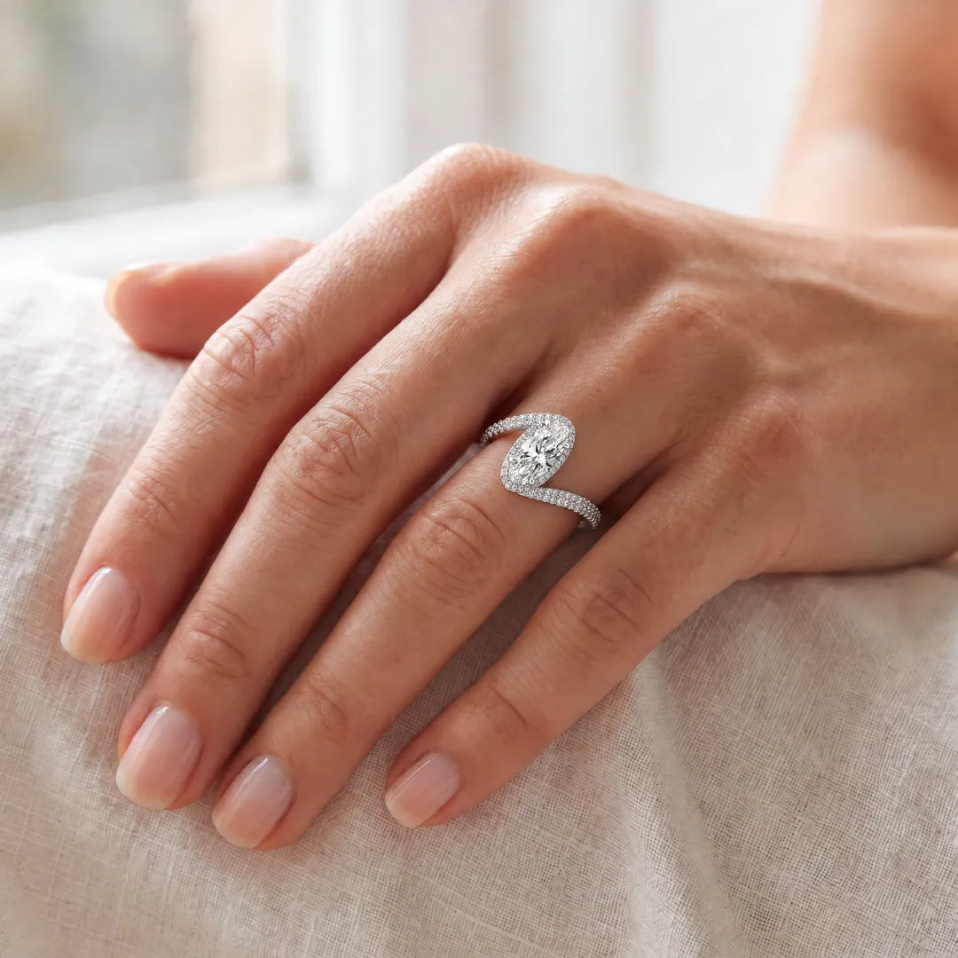 3.70ct elongated oval lab grown diamond bypass halo ring in platinum worn on a woman's hand