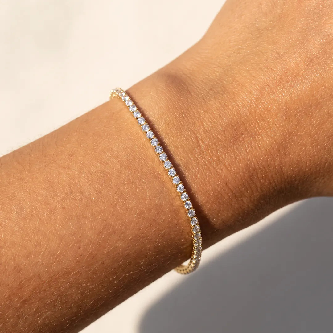 3.00ct lab grown diamond tennis bracelet in 9K yellow gold worn on a woman's wrist