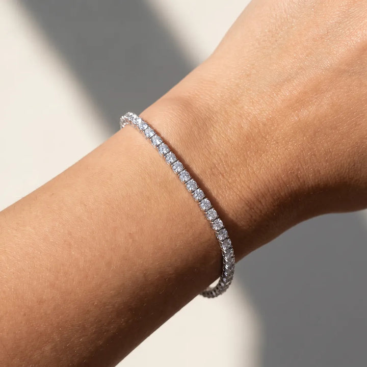 5.00ct lab grown diamond tennis bracelet in 9K white gold worn on a woman's wrist