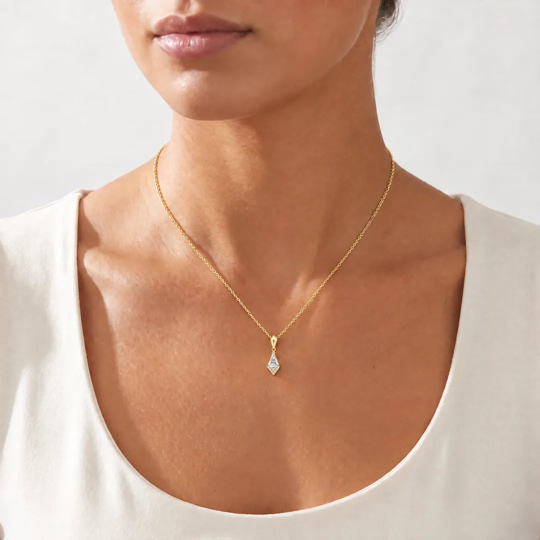 0.33ct Kite Lab Grown Diamond Asterly Necklace in 9K Yellow Gold worn on a model, showing the petite kite pendant on a fine yellow gold chain at the collarbone