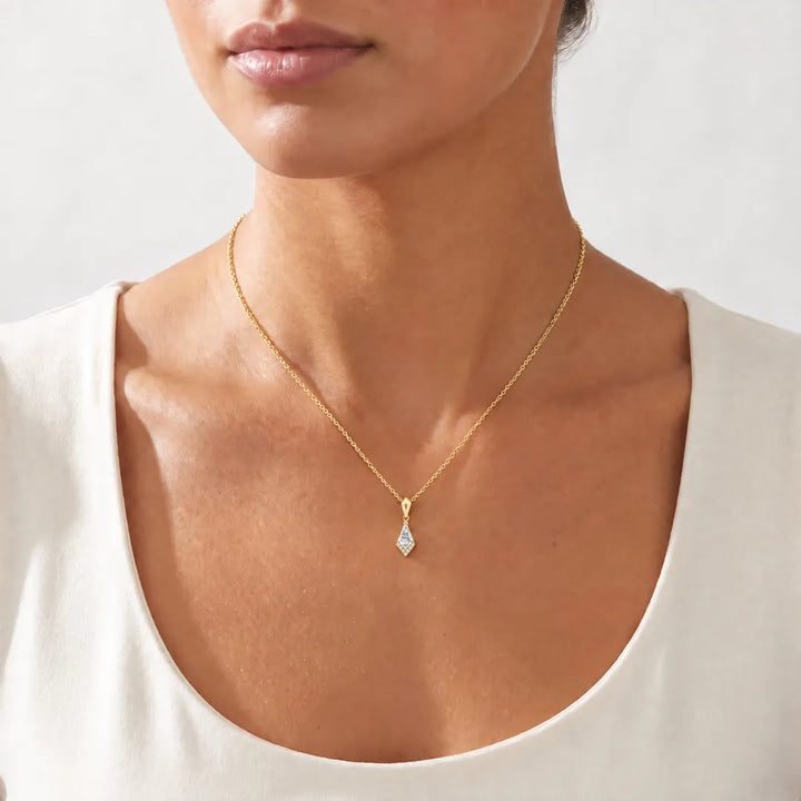 0.33ct Kite Lab Grown Diamond Asterly Necklace in 9K Yellow Gold worn on a model, showing the petite kite pendant on a fine yellow gold chain at the collarbone