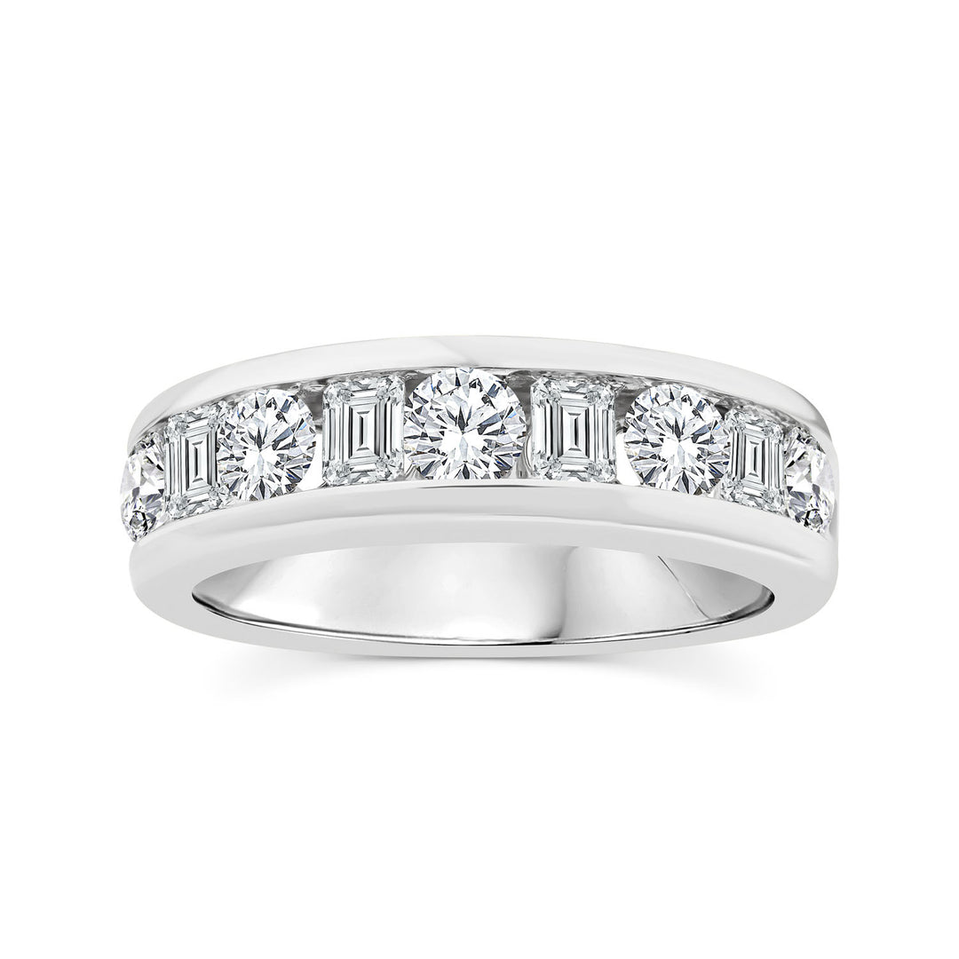 A silver diamond eternity ring featuring a row of baguette and round-cut diamonds set in a polished silver band, shown against a plain white background.