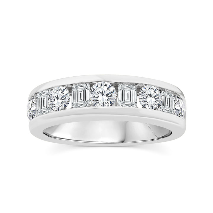 A silver diamond eternity ring featuring a row of baguette and round-cut diamonds set in a polished silver band, shown against a plain white background.