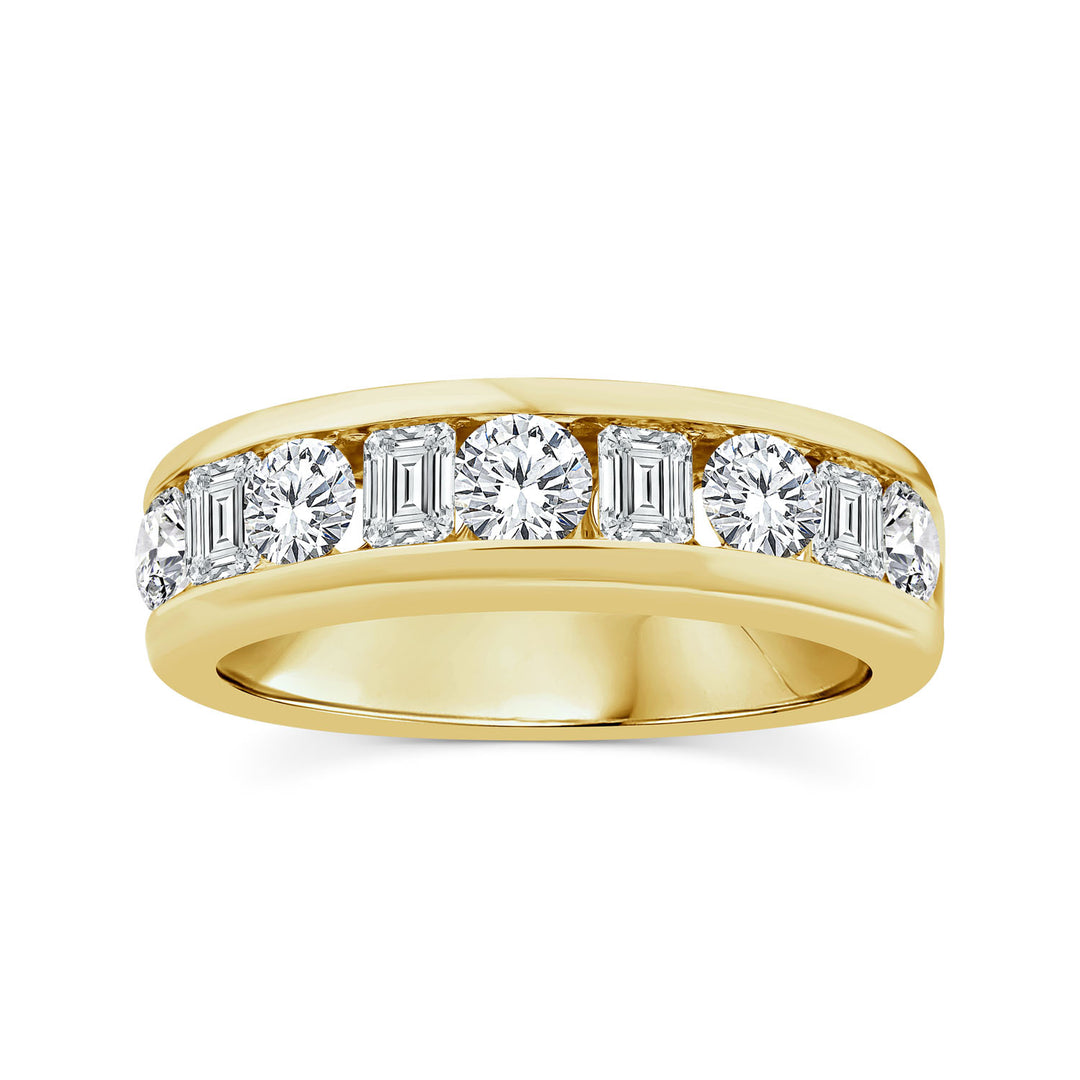 A gold diamond eternity ring featuring a row of baguette and round-cut diamonds set in a polished silver band, shown against a plain white background.