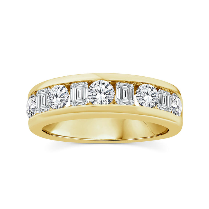 A gold diamond eternity ring featuring a row of baguette and round-cut diamonds set in a polished silver band, shown against a plain white background.