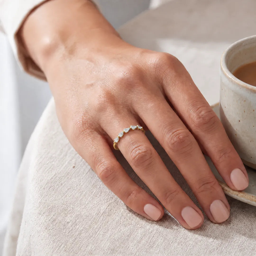 0.75ct shield lab grown diamond Asterly ring in 9K yellow gold worn on a model's hand