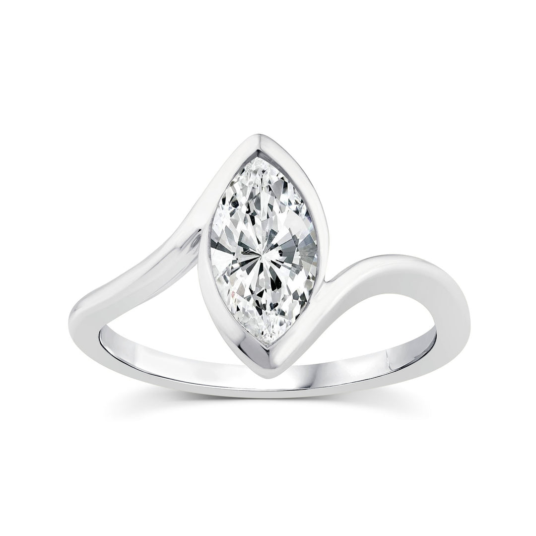 A silver-tone ring featuring a marquise-cut clear gemstone in a curved, wave-like setting on a plain white background.