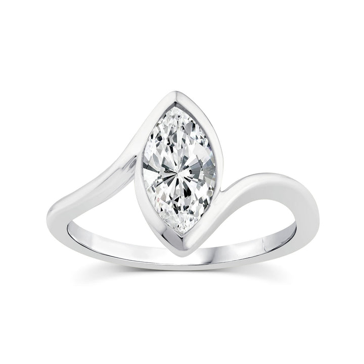 A silver-tone ring featuring a marquise-cut clear gemstone in a curved, wave-like setting on a plain white background.