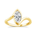Gold ring with a pear-shaped diamond on a white background