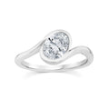 A silver engagement ring featuring a round brilliant-cut diamond set in a curved, wave-like band, shown on a clean white background.