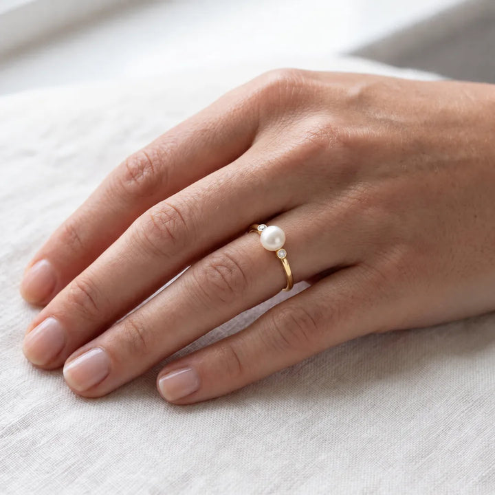 0.04ct Lab Grown Diamond Freshwater Pearl Ring in 9K Yellow Gold worn on a model's hand