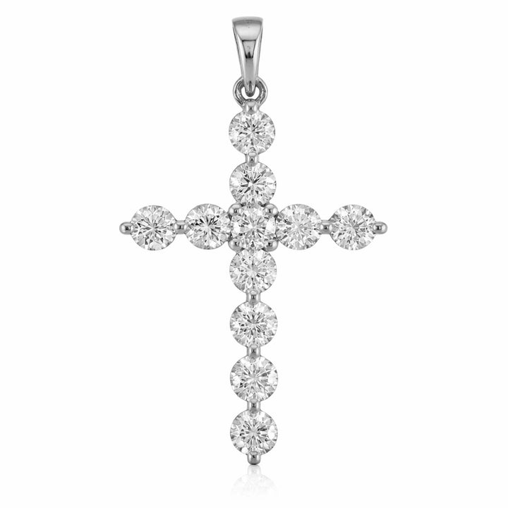 A silver cross pendant adorned with round-cut clear gemstones, set against a plain white background.