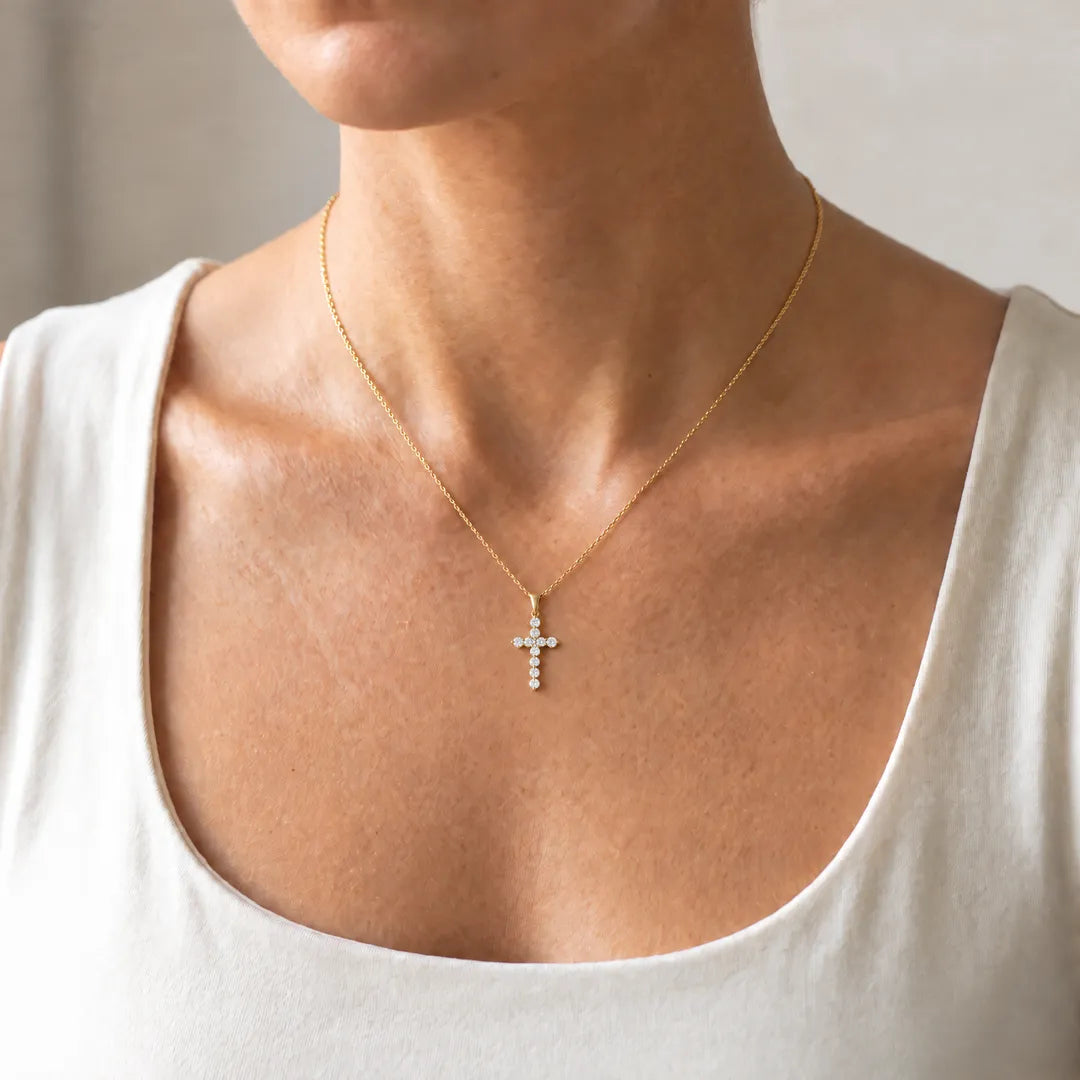 1.00ct Lab Grown Diamond Cross Pendant in 9K Yellow Gold worn on a fine yellow gold chain on a model