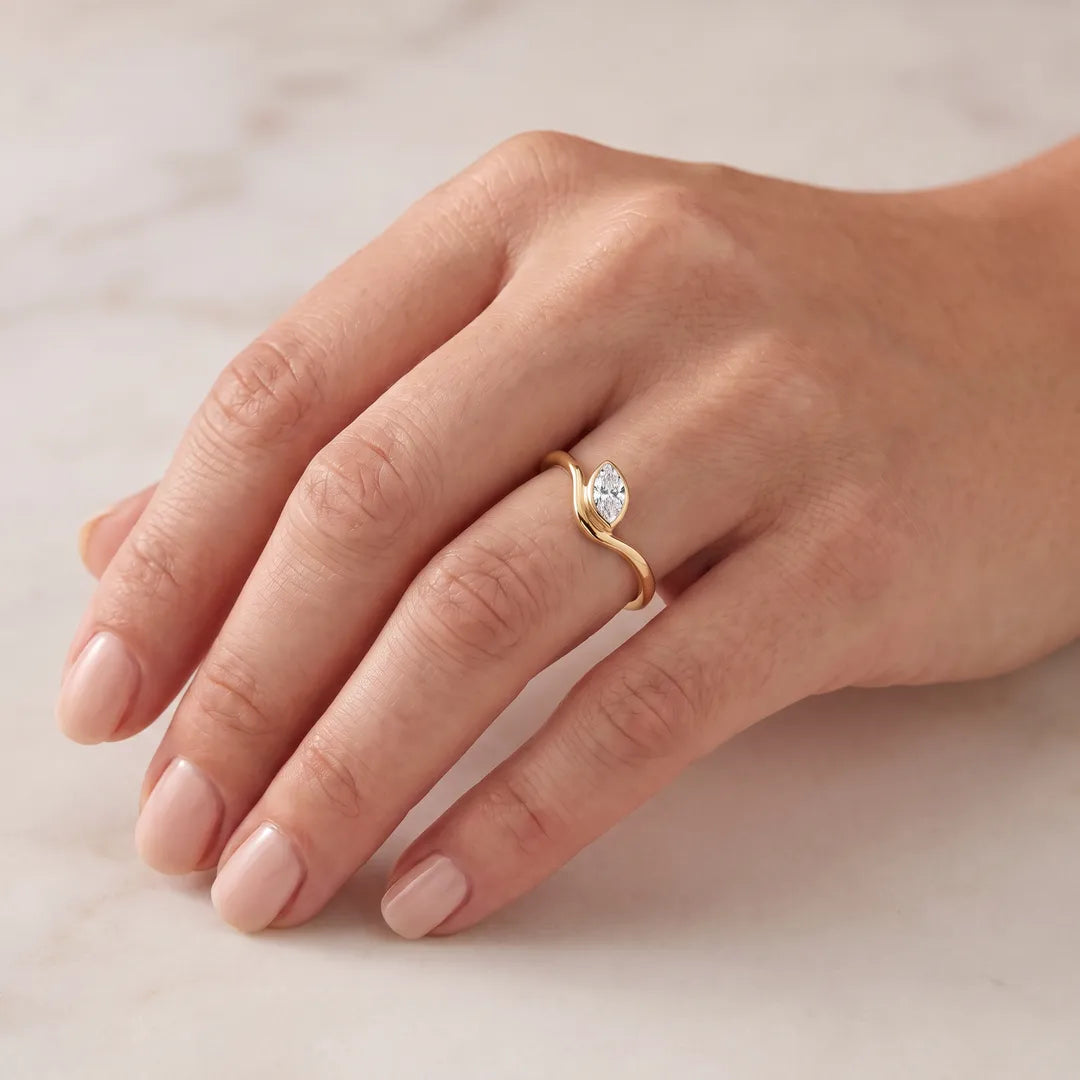 0.50ct Marquise Lab Grown Diamond Offset Ring in 9K Yellow Gold worn on a model's hand