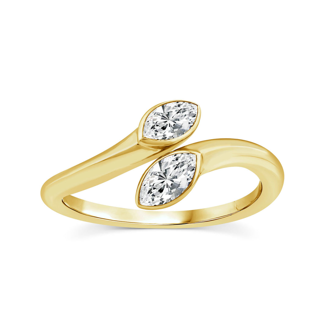 A yellow gold ring featuring two marquise-cut clear gemstones set in a curved, intertwined band design, shown on a plain white background.