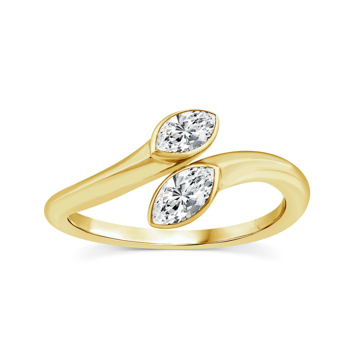 A yellow gold ring featuring two marquise-cut clear gemstones set in a curved, intertwined band design, shown on a plain white background.