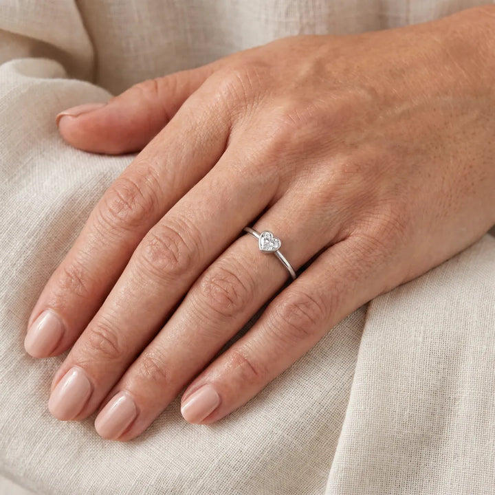 0.20ct heart lab grown diamond ring in 9K white gold worn on a woman's ring finger