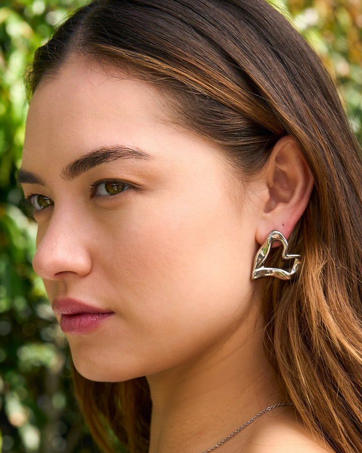 Aurelia Organic Heart Stud Earrings in Silver styled on a model — Zoe Olivia