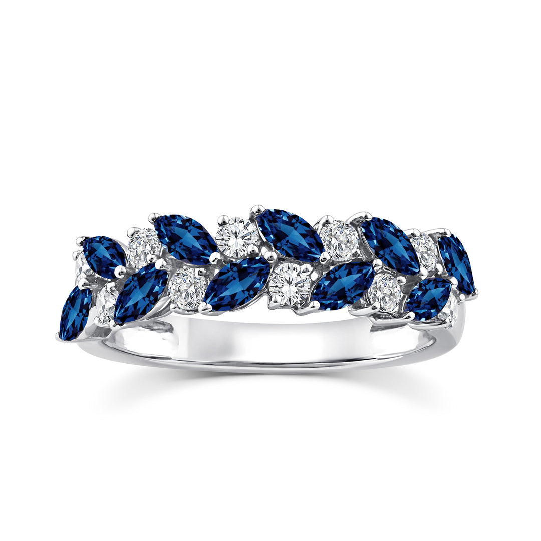 A silver band ring featuring a double row of marquise-cut blue sapphires and round brilliant-cut diamonds, set against a clean white background.