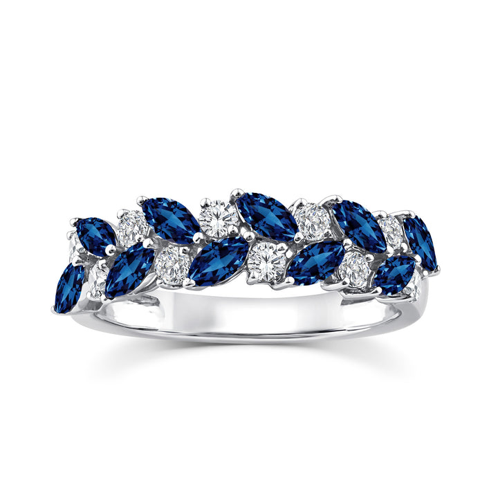 A silver band ring featuring a double row of marquise-cut blue sapphires and round brilliant-cut diamonds, set against a clean white background.
