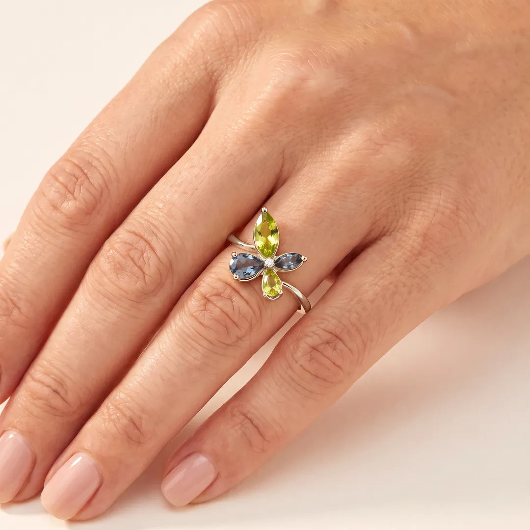 0.01ct Diamond, Topaz & Peridot butterfly cluster ring in 9K white gold worn on a model's ring finger