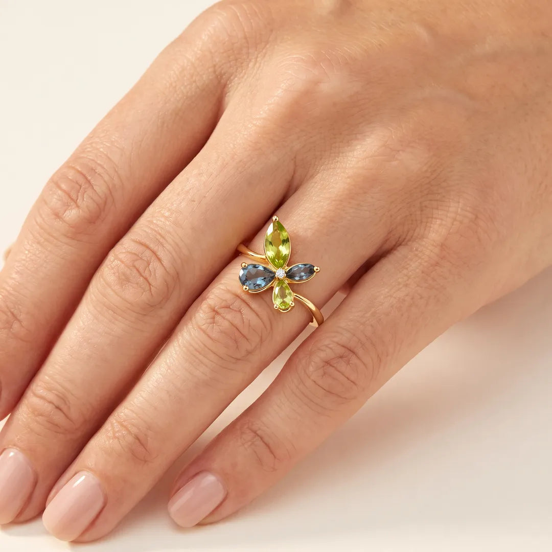 0.01ct Diamond, Topaz & Peridot butterfly cluster ring in 9K yellow gold worn on a model's ring finger