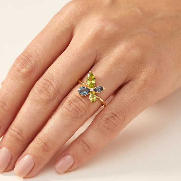 0.01ct Diamond, Topaz & Peridot butterfly cluster ring in 9K yellow gold worn on a model's ring finger