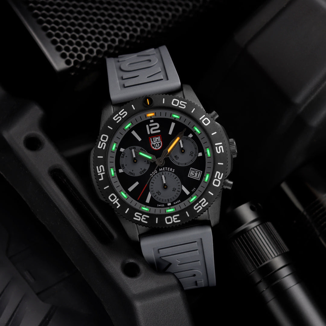 Black and gray watch with digital display on a dark background